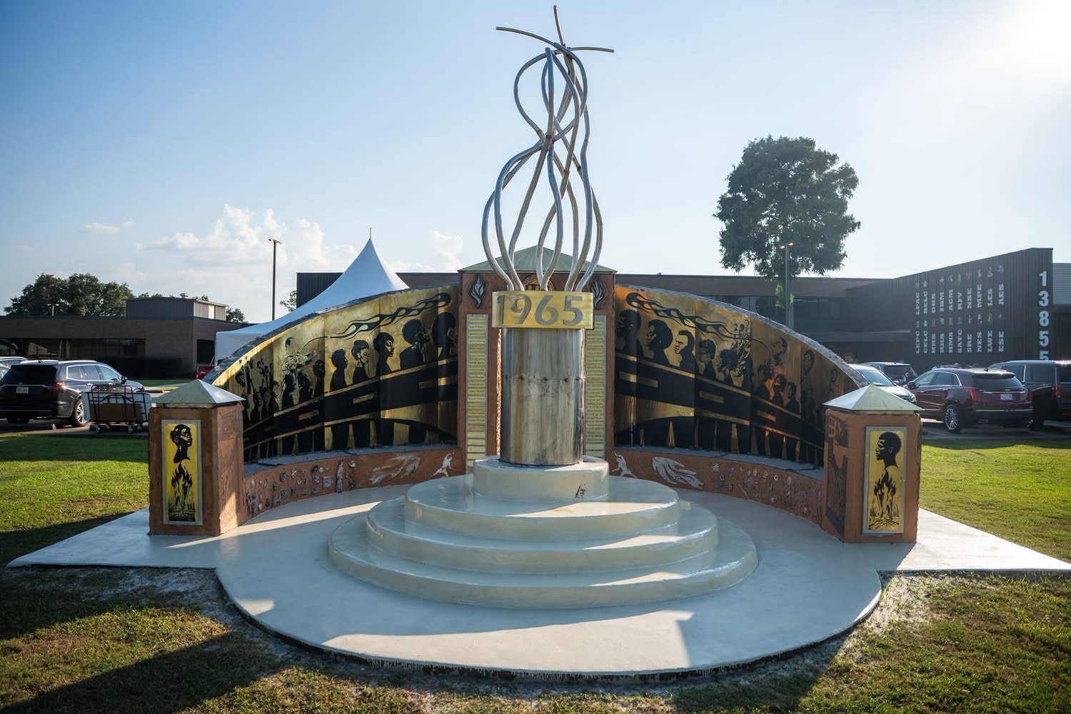 The completed memorial with the 1965 flame and bronze story panels