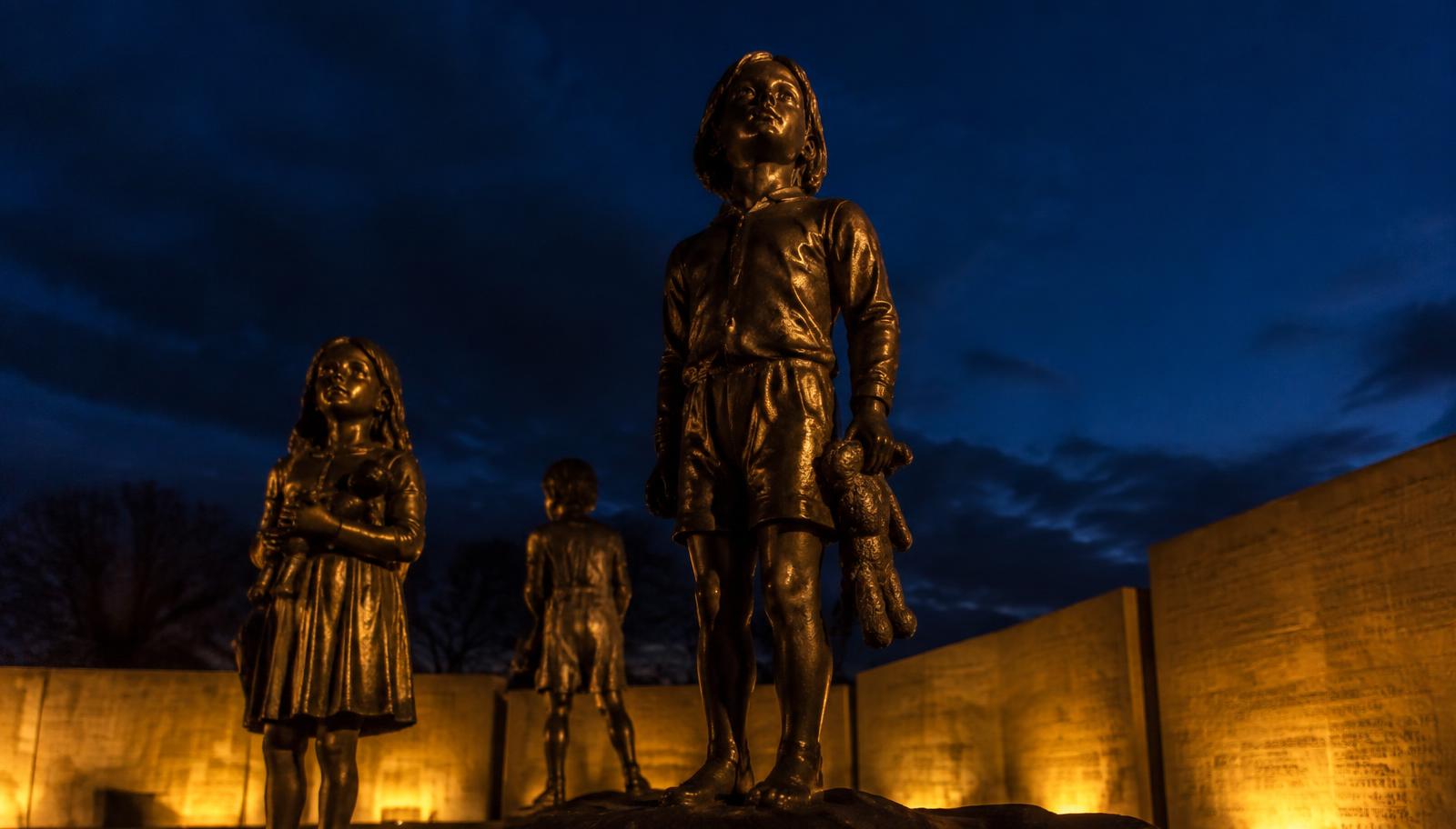 The bronze 43 Trailblazers Memorial lit at night